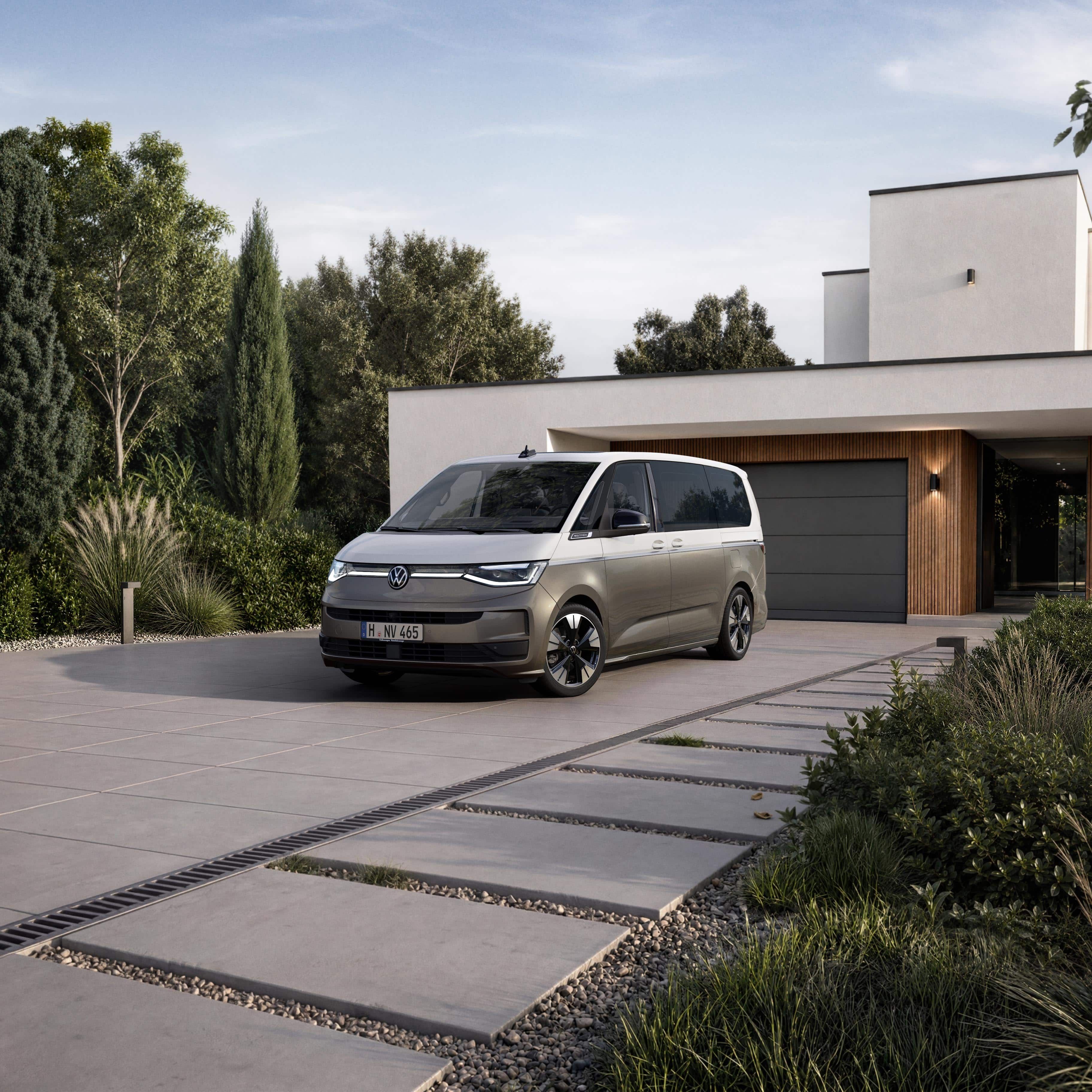 VW Multivan num caminho de acesso em frente a uma casa moderna.