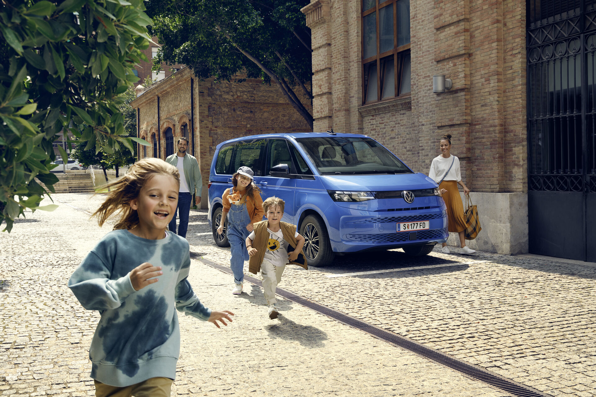 Uma família estacionou a VW Multivan na beira da estrada para um dia na cidade.