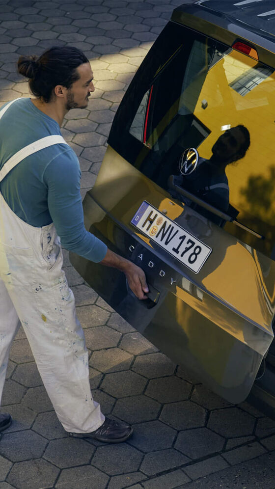 Homens trabalhadores pintores a utilizar o VW Caddy Maxi